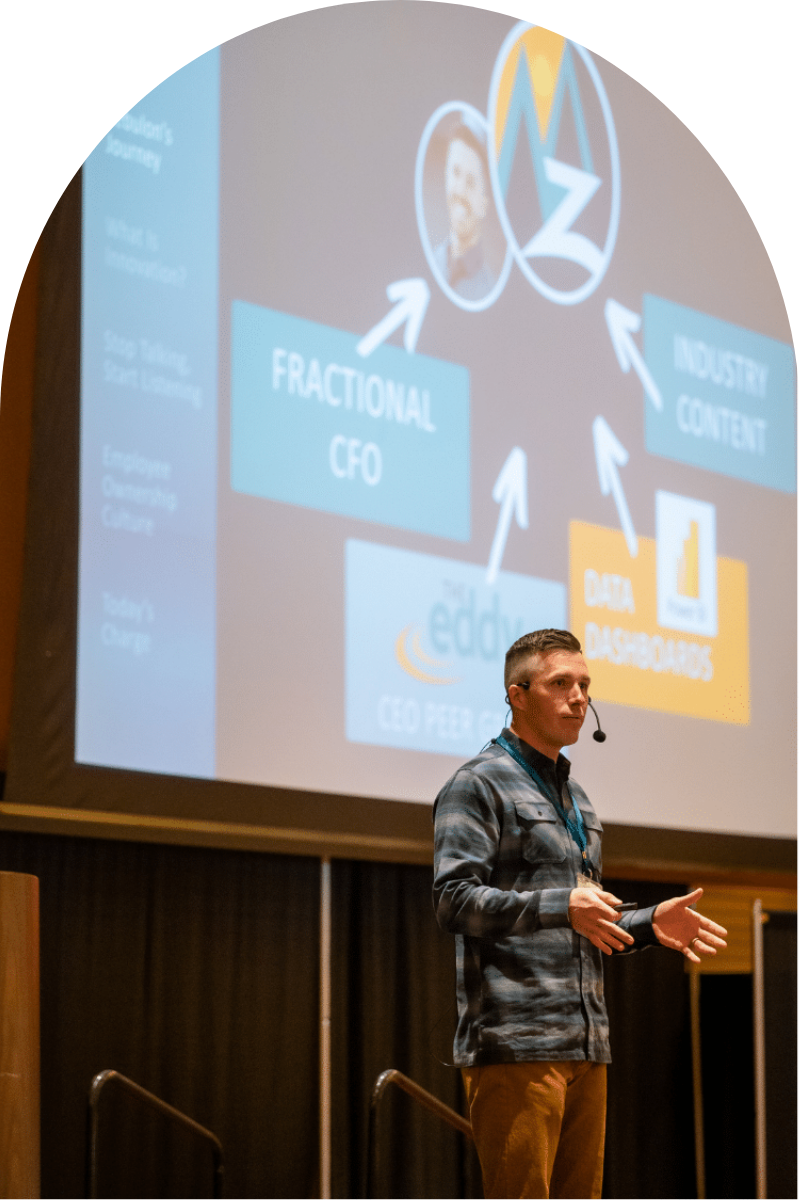 Zeb Smith, founder of Zebulon LLC, presenting at an industry conference on business education & financial growth.